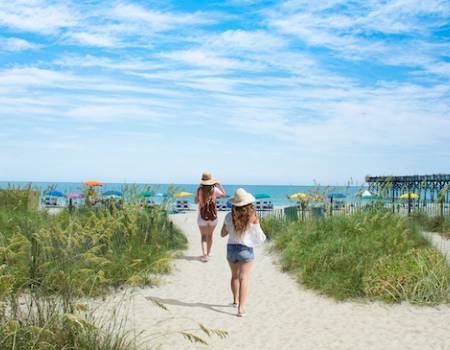 girls walking to beach