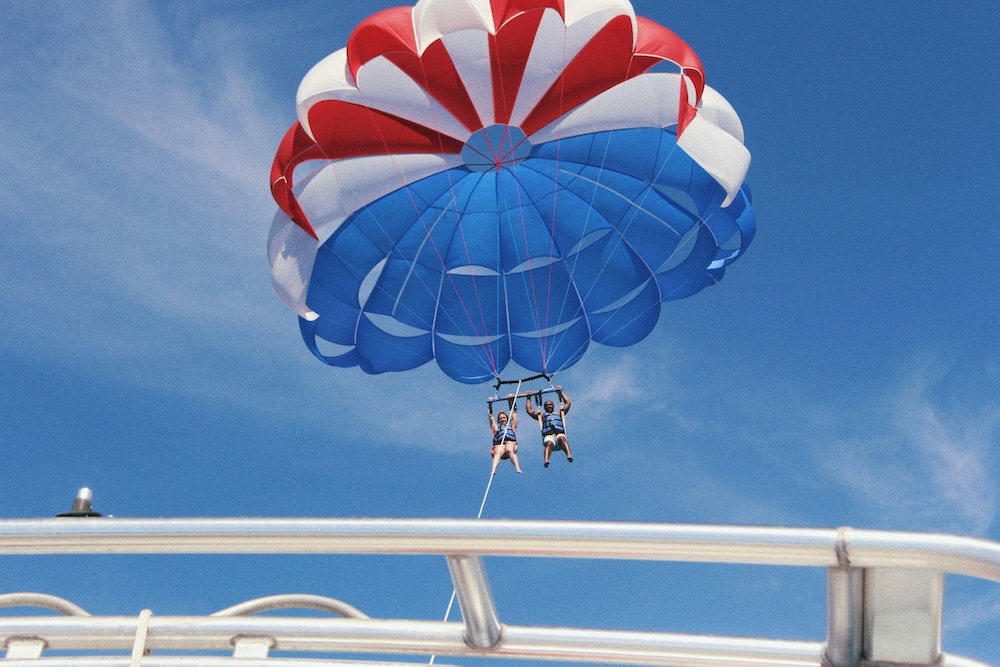 Friends parasailing at the beach